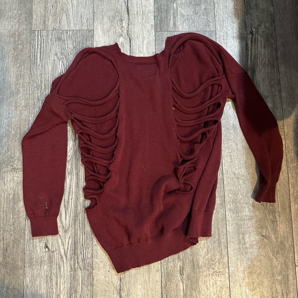 Maroon sweater with ropes in the back